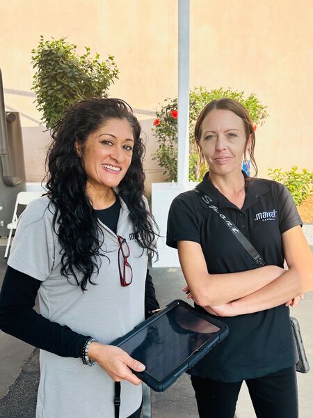 Marvel Car Wash team members with tablet