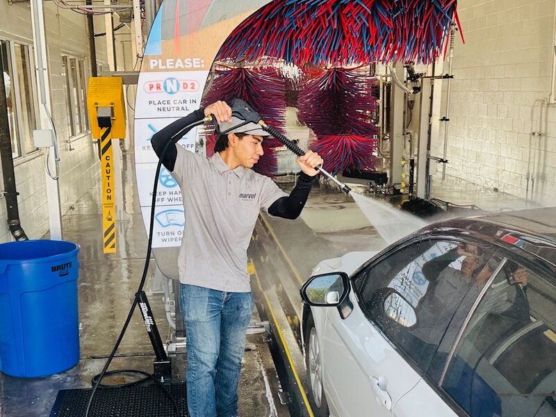 Team member pre-spraying vehicle before tunnel
